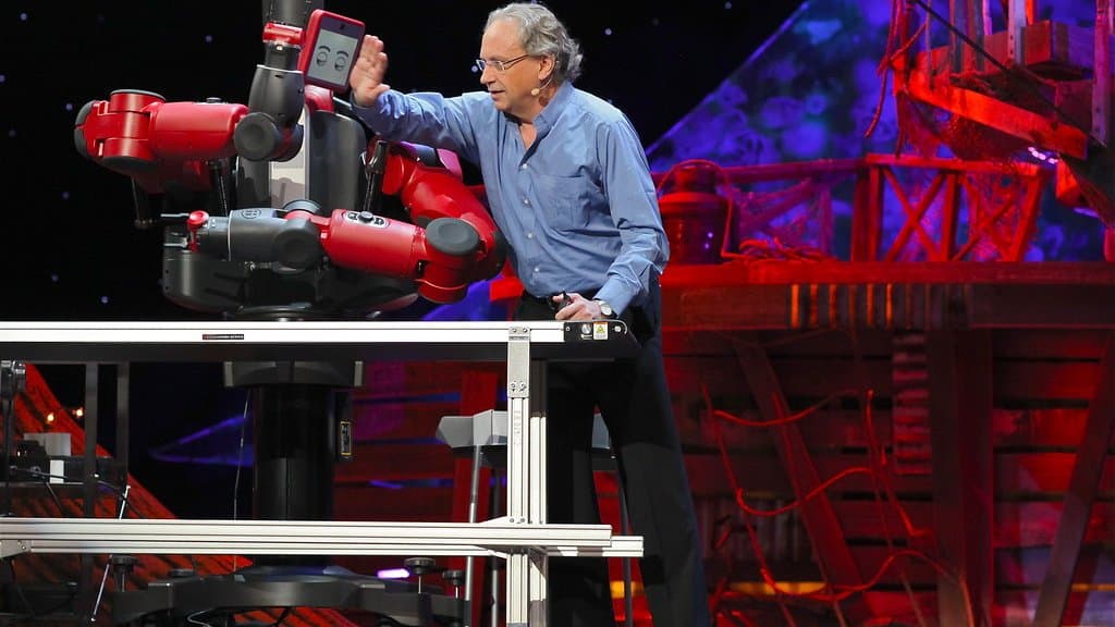 A person interacting hand-to-hand with a white humanoid robot