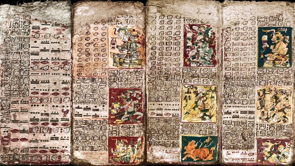 Pages of the Maya Dresden Codex covered in hieroglyphic script and astronomical tables including Venus cycles