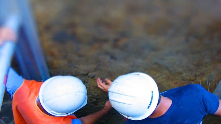 Geologists examining an exposed fault in the field