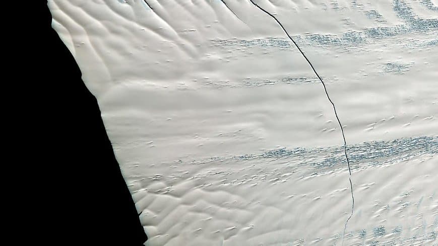 Aerial view of the Pine Island Glacier, a fast-flowing West Antarctic ice stream, showing crevassed ice meeting the sea