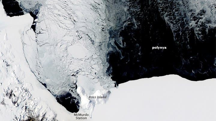 Satellite view of dark open water forming a lead or polynya within bright Antarctic sea ice