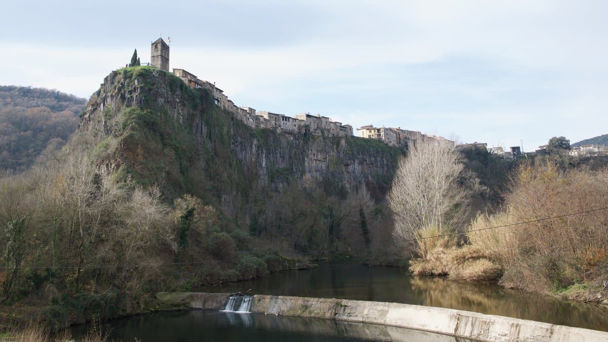 The village of Castellfollit de la Roca perched on a basalt cliff formed by lava flows in La Garrotxa, Catalonia