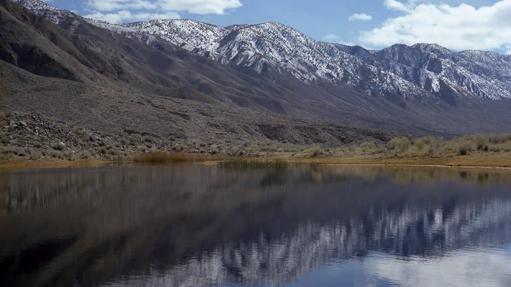 A geological fault zone running along the base of desert mountains