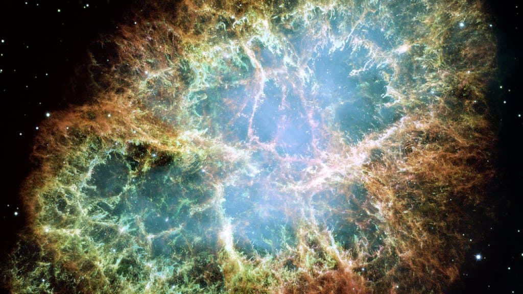 The Crab Nebula, a filamentary supernova remnant surrounding a central pulsar, imaged by Hubble.