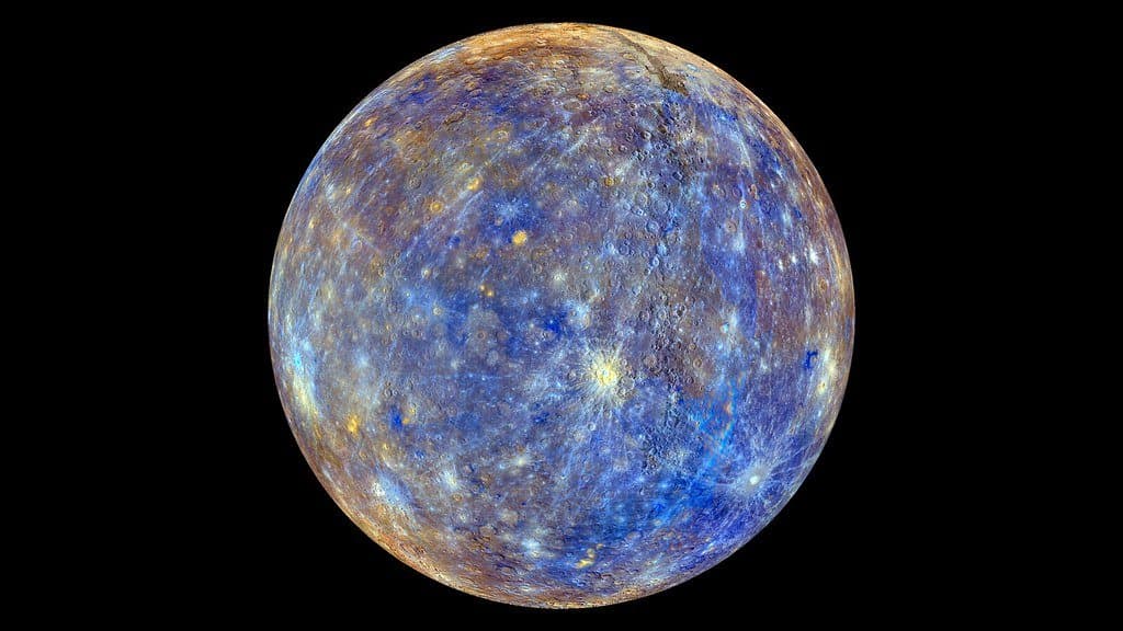 A false-colour view of Mercury's cratered globe, mineral differences picked out in blues, tans and oranges.