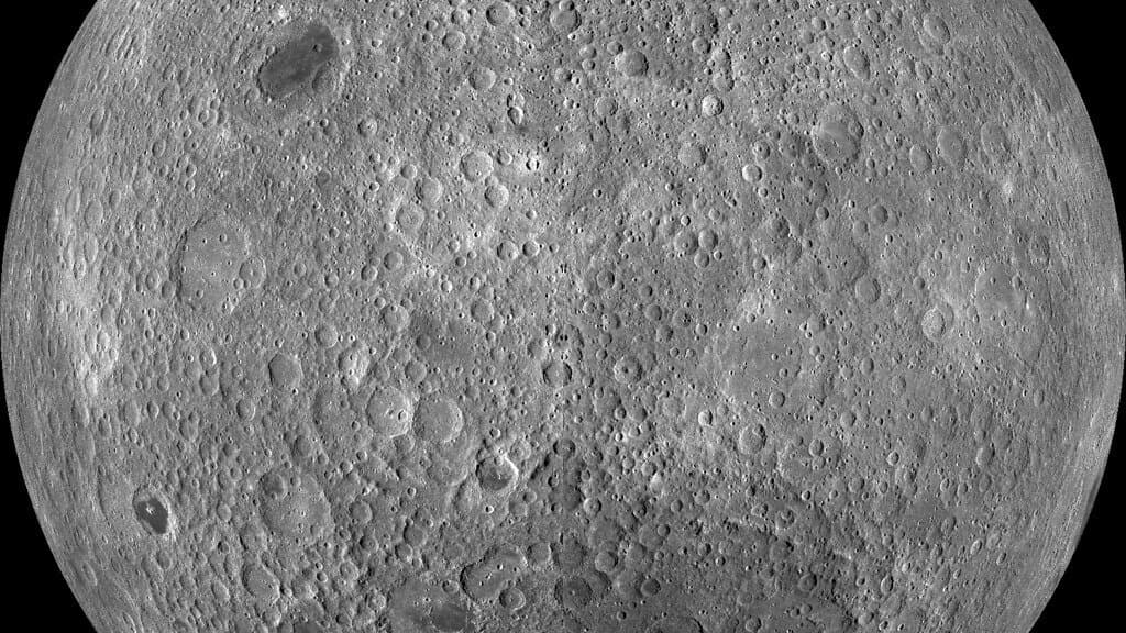 The Moon's far side seen from lunar orbit: a grey hemisphere covered edge to edge with overlapping impact craters and no dark volcanic plains.