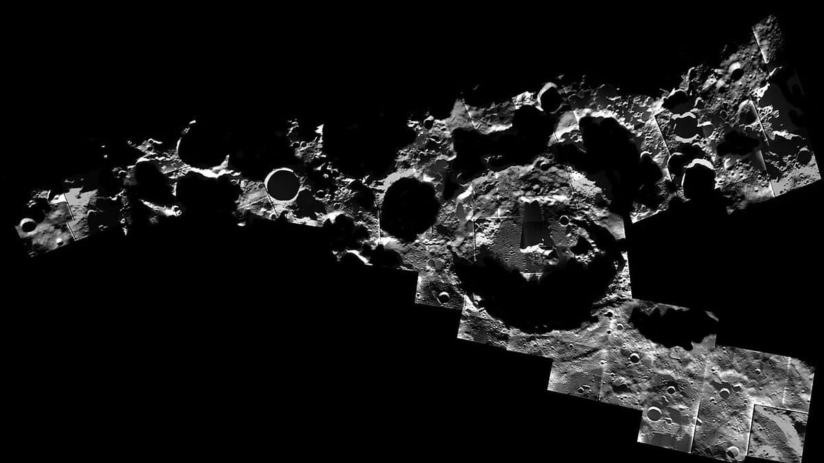 Cratered grey terrain at the Moon's south pole, with low sunlight leaving long black shadows across crater floors and rims.