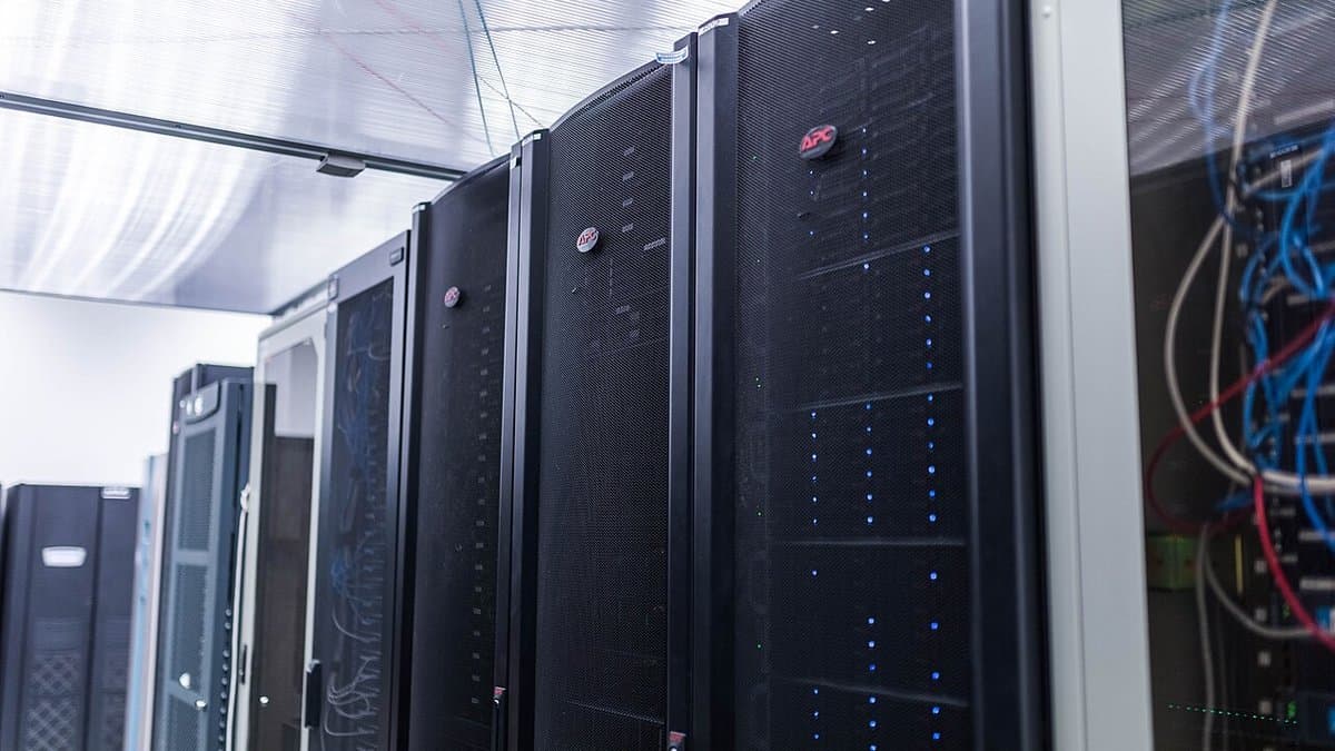 Rows of rack-mounted servers with cabling in a computing centre