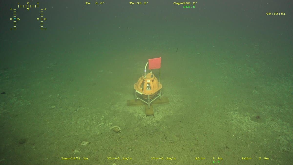 An ocean-bottom seismometer standing on a silty seabed, seen from a remotely operated vehicle