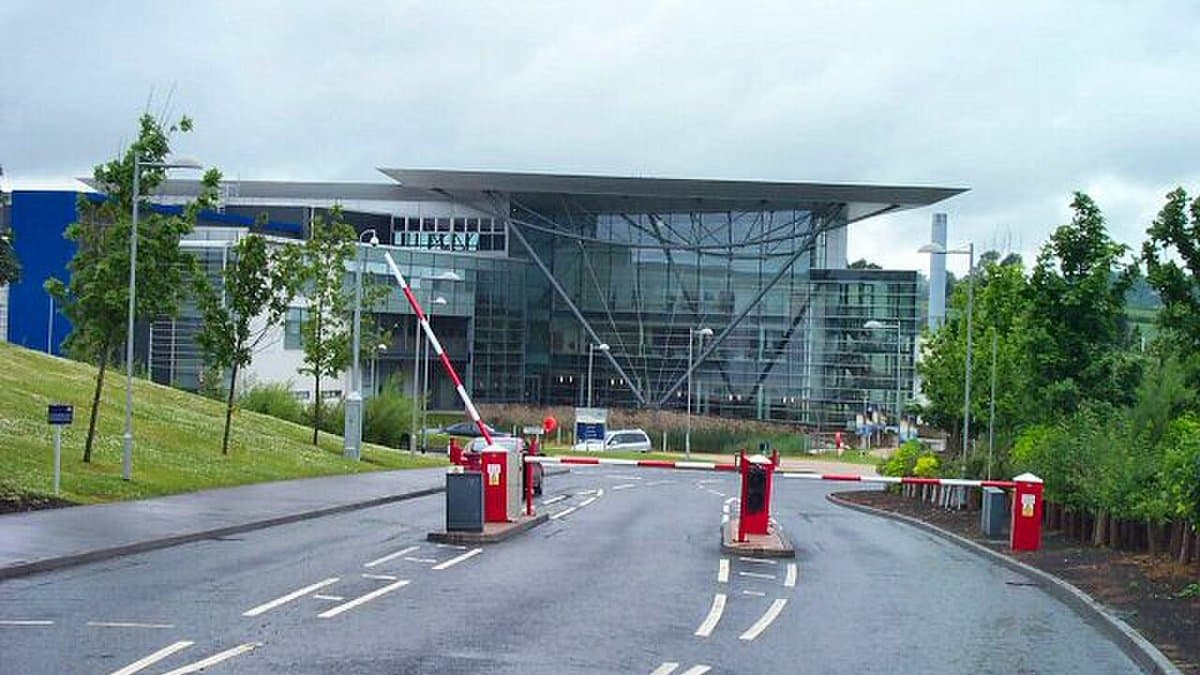 The entrance to the Met Office headquarters in Exeter, Devon, a low glass-fronted building with a wide overhanging roof
