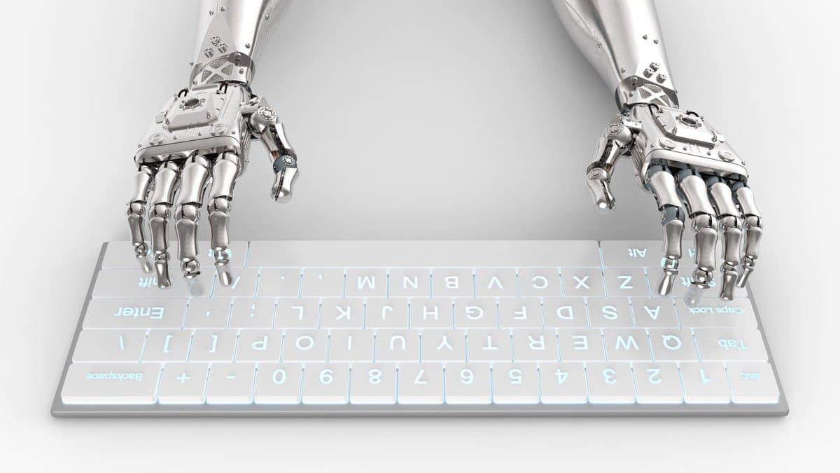 A three-dimensional render of two silver robotic hands typing on a glowing white computer keyboard.