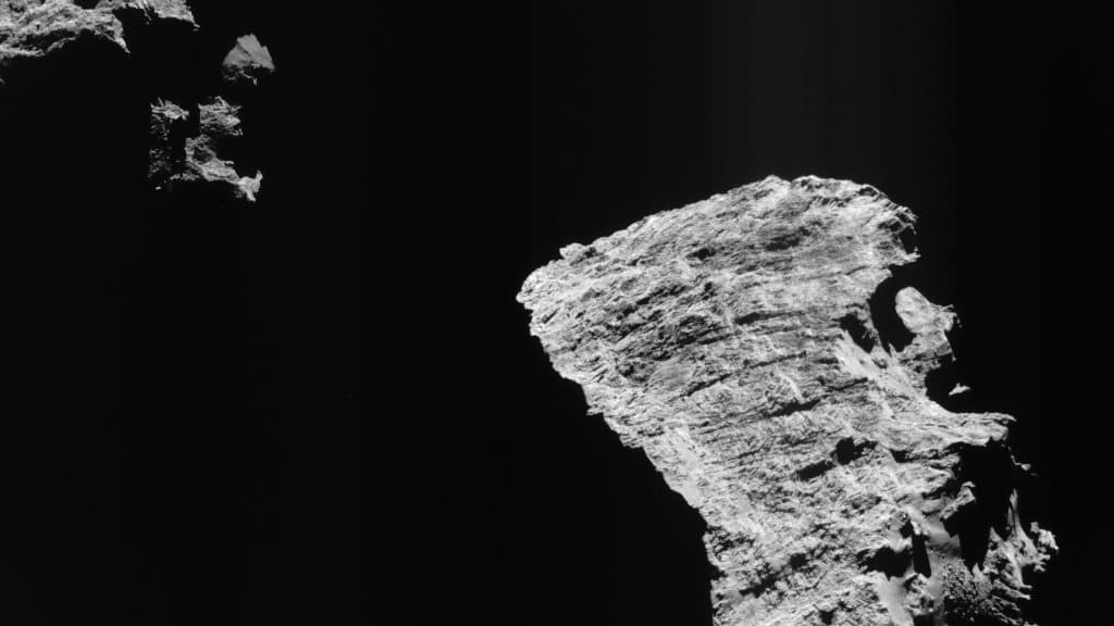 Close-up of the cliffs and dust-covered surface of comet 67P/Churyumov-Gerasimenko.