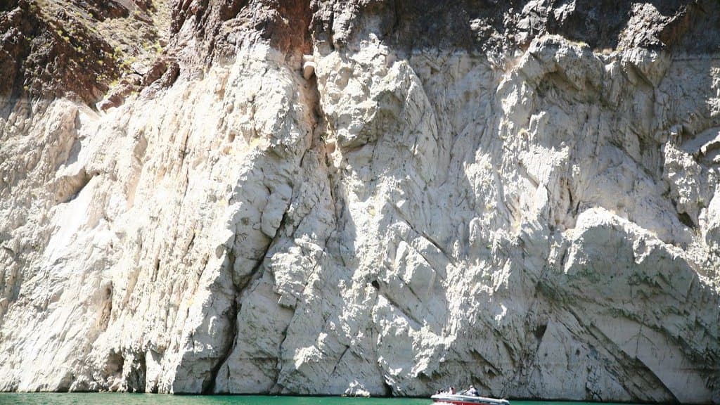 Lake Mead at low water, a pale mineral bathtub ring exposed above the waterline on the surrounding rock.