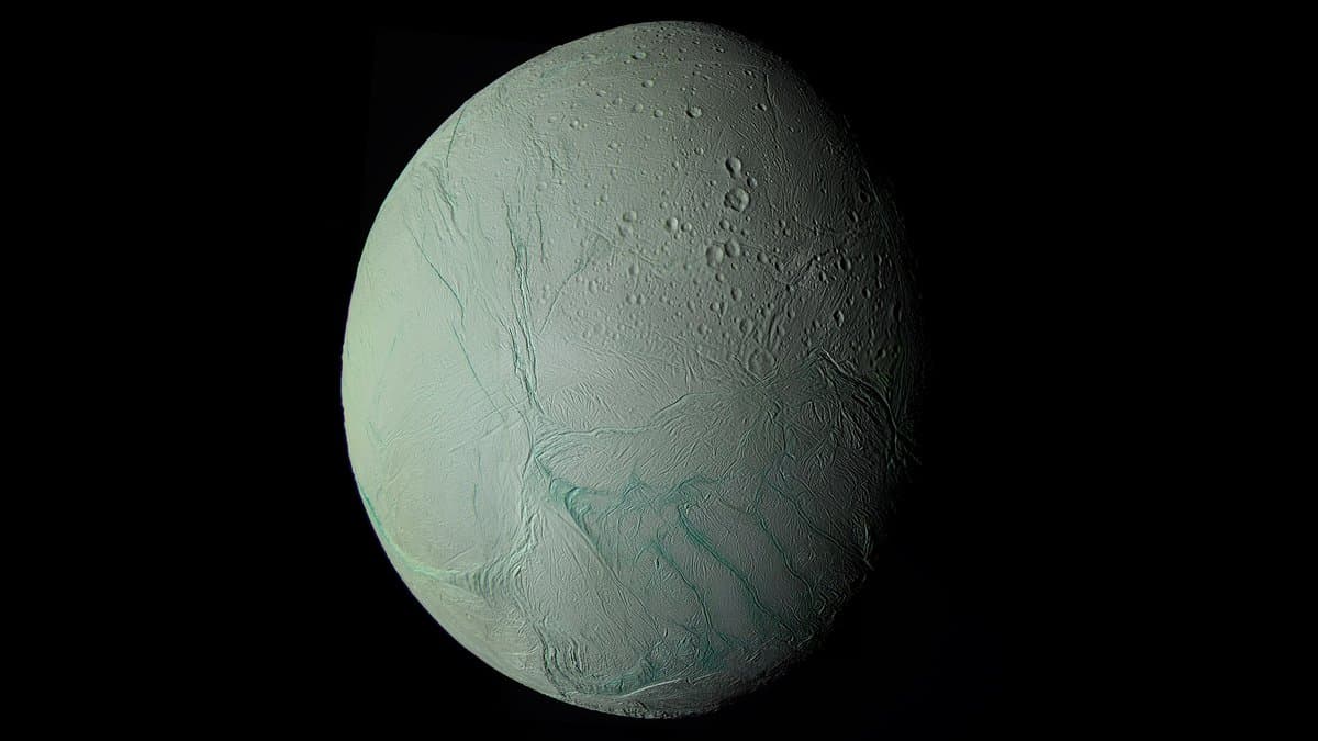The icy globe of Saturn's moon Enceladus, with a network of long parallel fractures, the tiger stripes, crossing its south polar region.