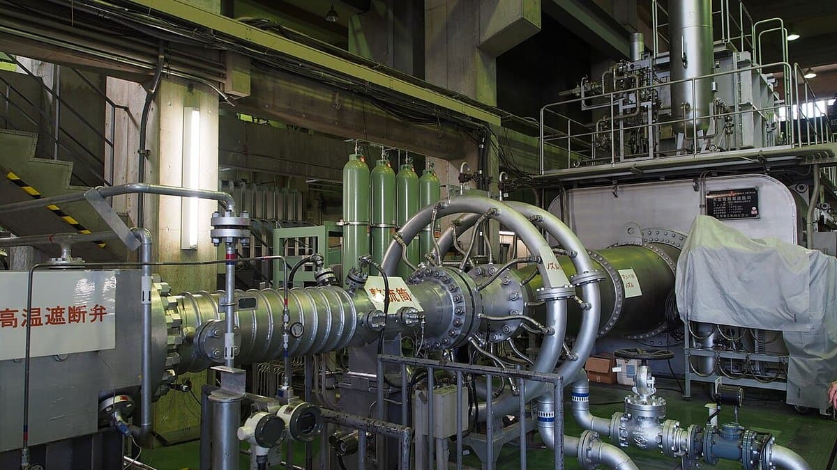 Pipework, valves, pressure vessels and gas cylinders of a hypersonic wind tunnel inside an industrial test hall.