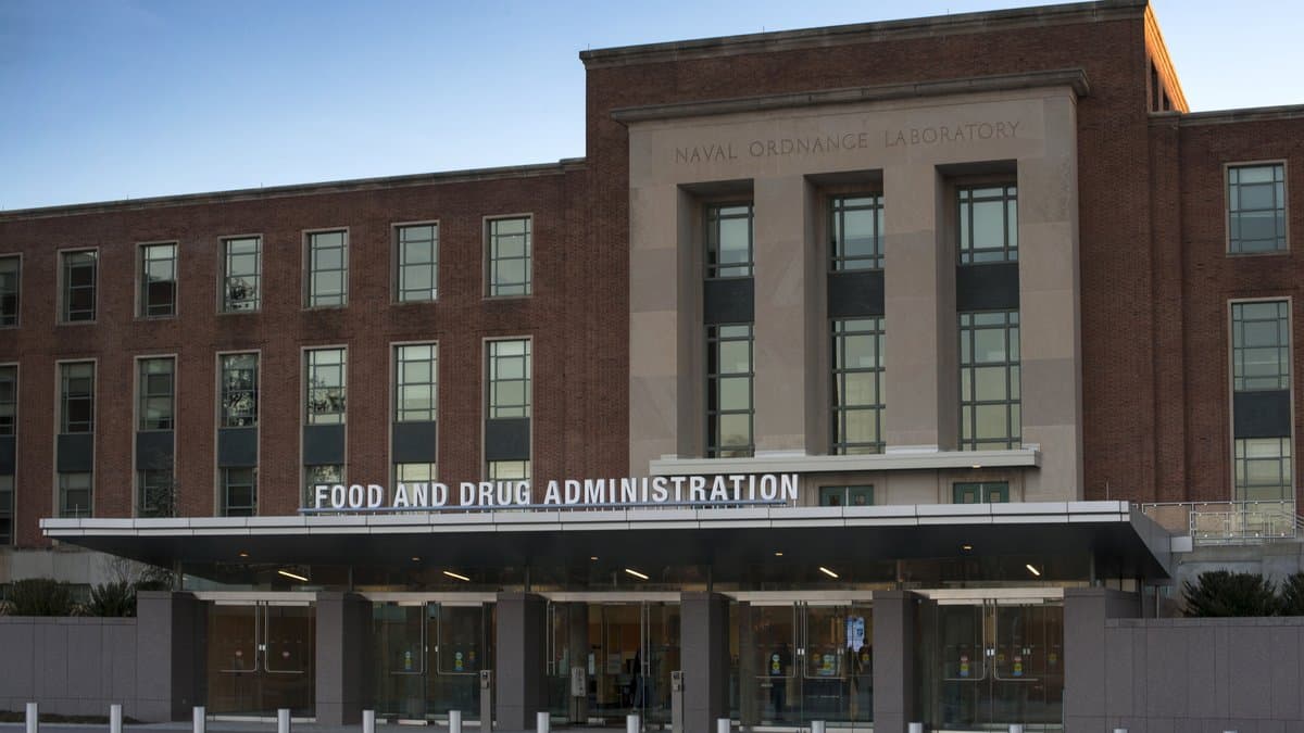 The main entrance of a brick office building, with FOOD AND DRUG ADMINISTRATION lettering across the entrance canopy.