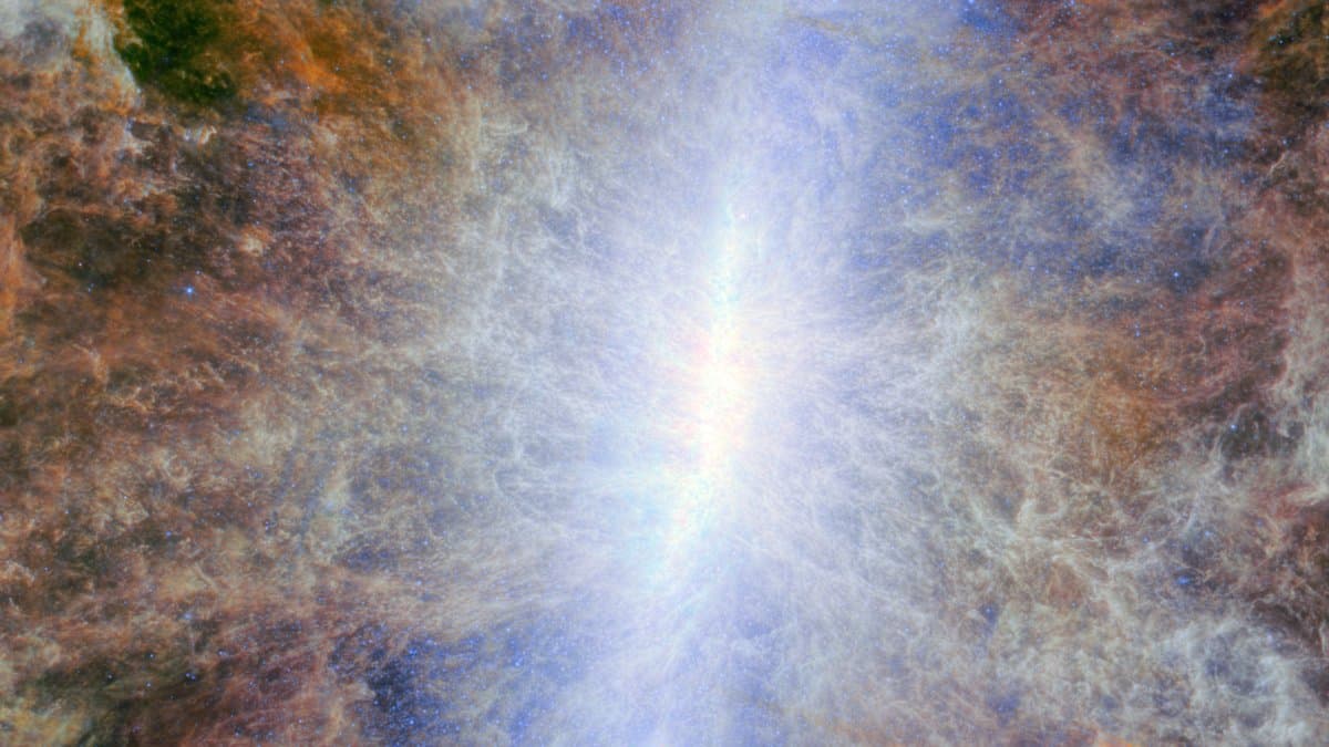 Infrared view of a starburst galaxy's brilliant core, with filaments of dust and gas streaming outward above and below the galactic plane.