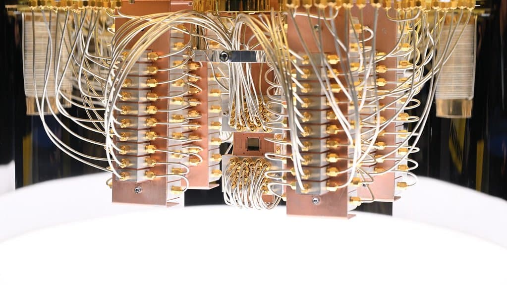 Gold-plated microwave cables and copper mounting blocks inside the cryostat of an IBM Q System One quantum computer.