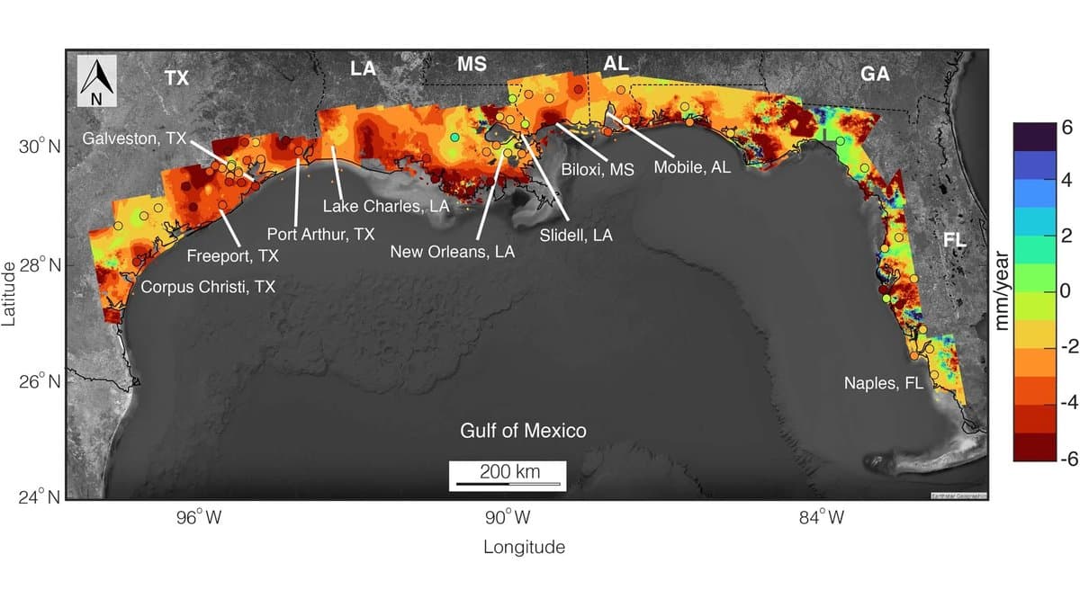 Satellite-based map of the US Gulf Coast from Texas to Florida, with the coastal strip shaded red, orange and green for vertical land motion in millimeters per year.