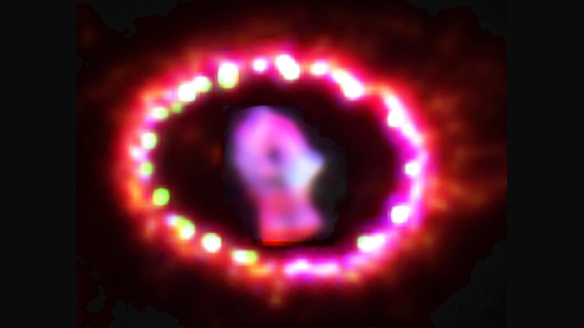 The bright ring of gas around Supernova 1987A, studded with glowing hot spots, with the debris of the explosion glowing at its center.