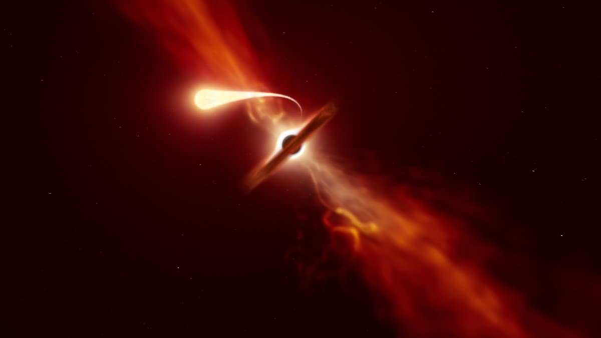 Artist's impression of a star drawn into a long, bright stream of gas as it is torn apart by a supermassive black hole, with debris blown outward from a glowing disk.