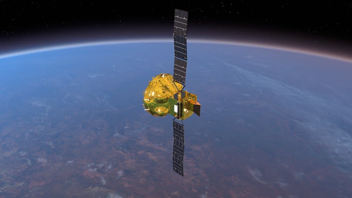 Artist's impression of the Smile spacecraft in orbit above Earth, its long solar panels deployed either side of a gold-wrapped payload module.