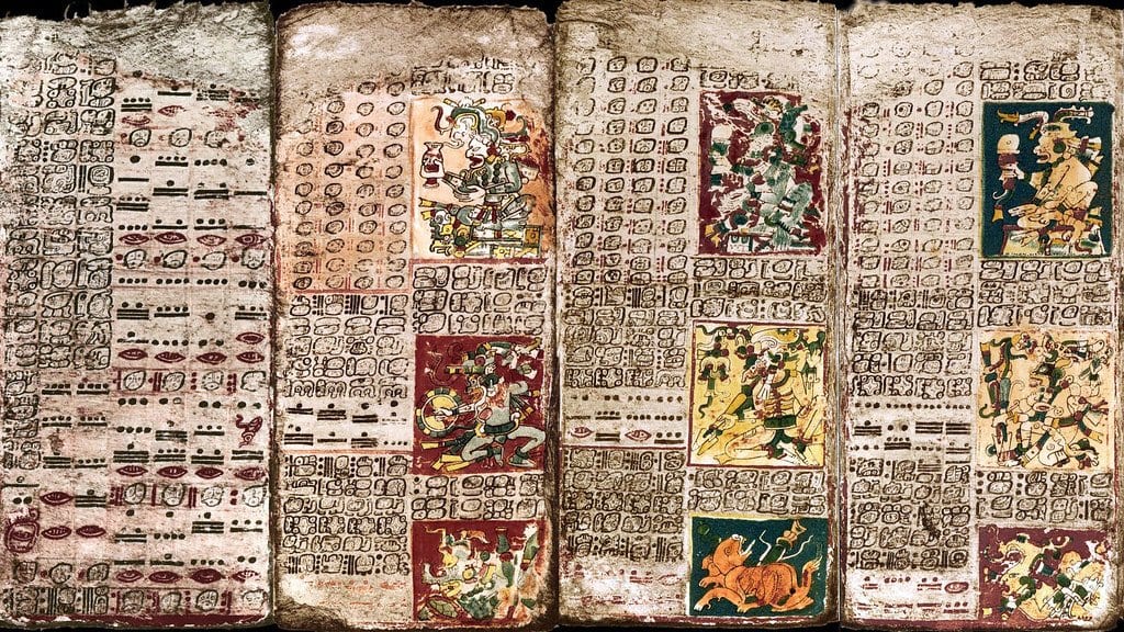 Pages of the Maya Dresden Codex covered in hieroglyphic script and astronomical tables including Venus cycles