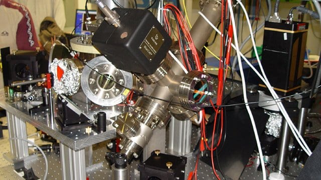 A gold-coloured ion-trap chip used as the qubit hardware in a trapped-ion quantum computer