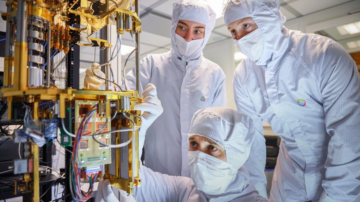 Close-up photograph of a superconducting quantum processor chip mounted in its hardware package