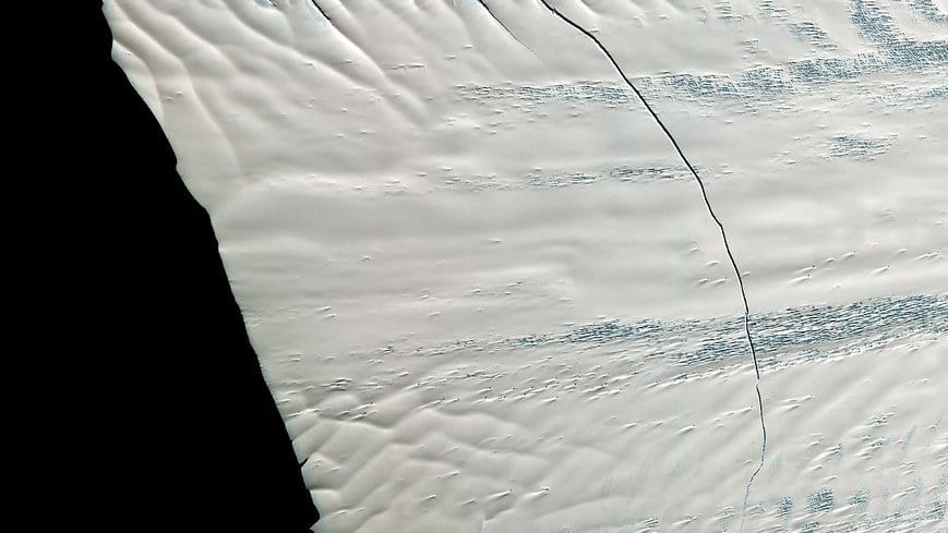 Aerial view of the Pine Island Glacier, a fast-flowing West Antarctic ice stream, showing crevassed ice meeting the sea