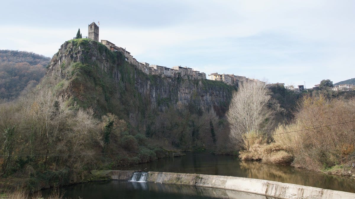 The village of Castellfollit de la Roca perched on a basalt cliff formed by lava flows in La Garrotxa, Catalonia