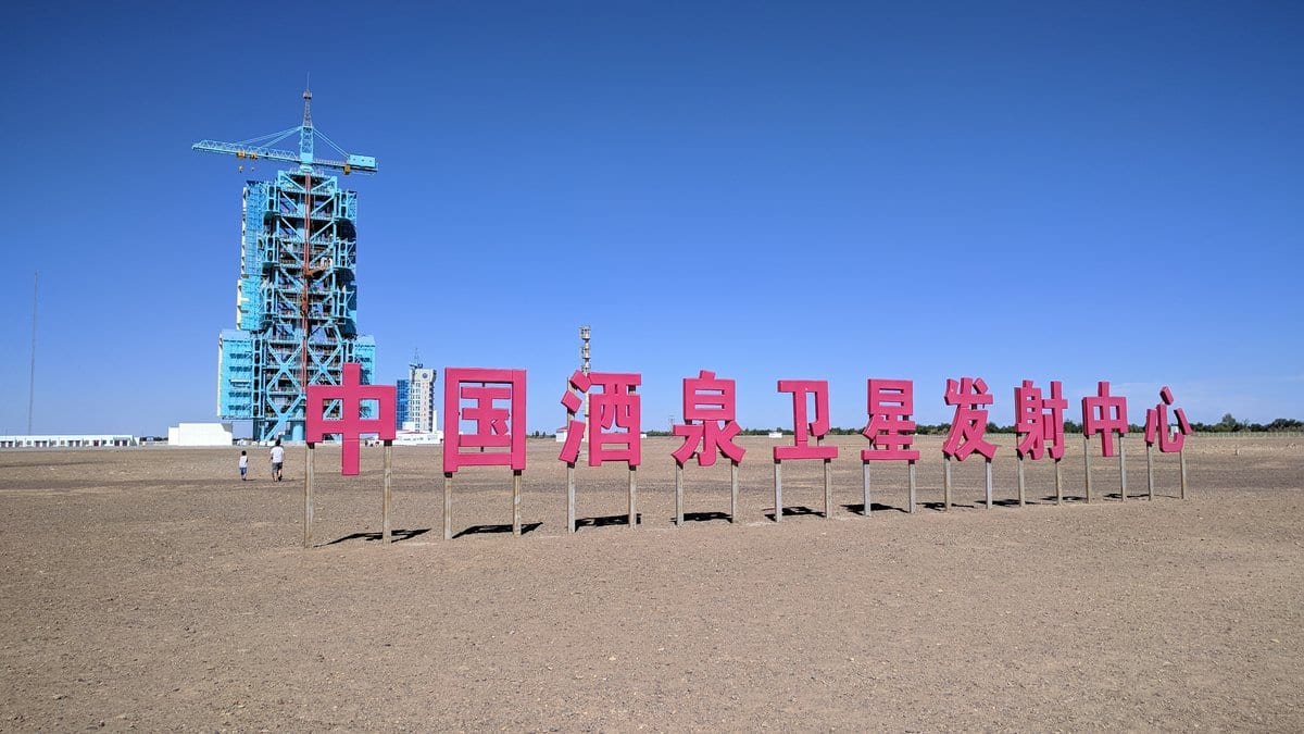 A launch tower and site sign at the Jiuquan Satellite Launch Center in the northwestern Chinese desert