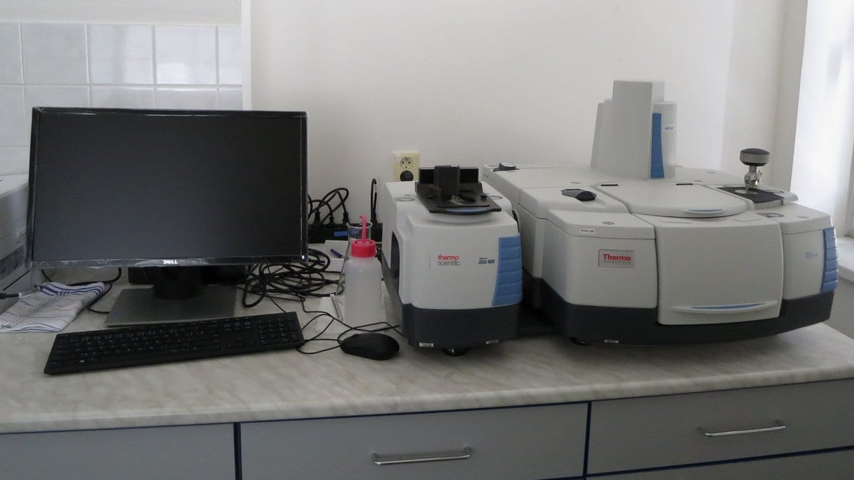 A benchtop infrared spectrometer standing on a laboratory bench