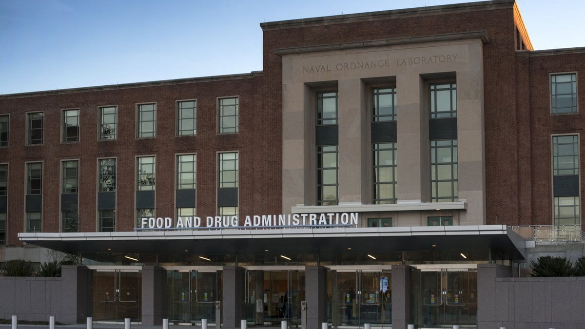 The main entrance of a brick office building, with FOOD AND DRUG ADMINISTRATION lettering across the entrance canopy.