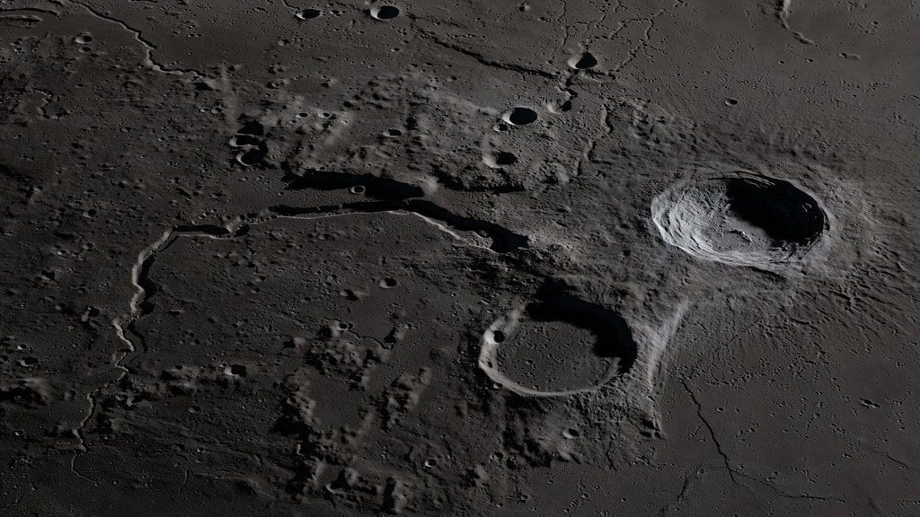 An oblique view of the Moon's Aristarchus plateau, showing a bright crater and a winding channel cut by ancient lava flows.