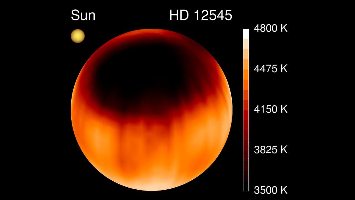 A map of the star HD 12545 showing a giant dark starspot across one hemisphere, the Sun drawn to the same scale at upper left, and a temperature scale from 3500 to 4800 kelvin at right.