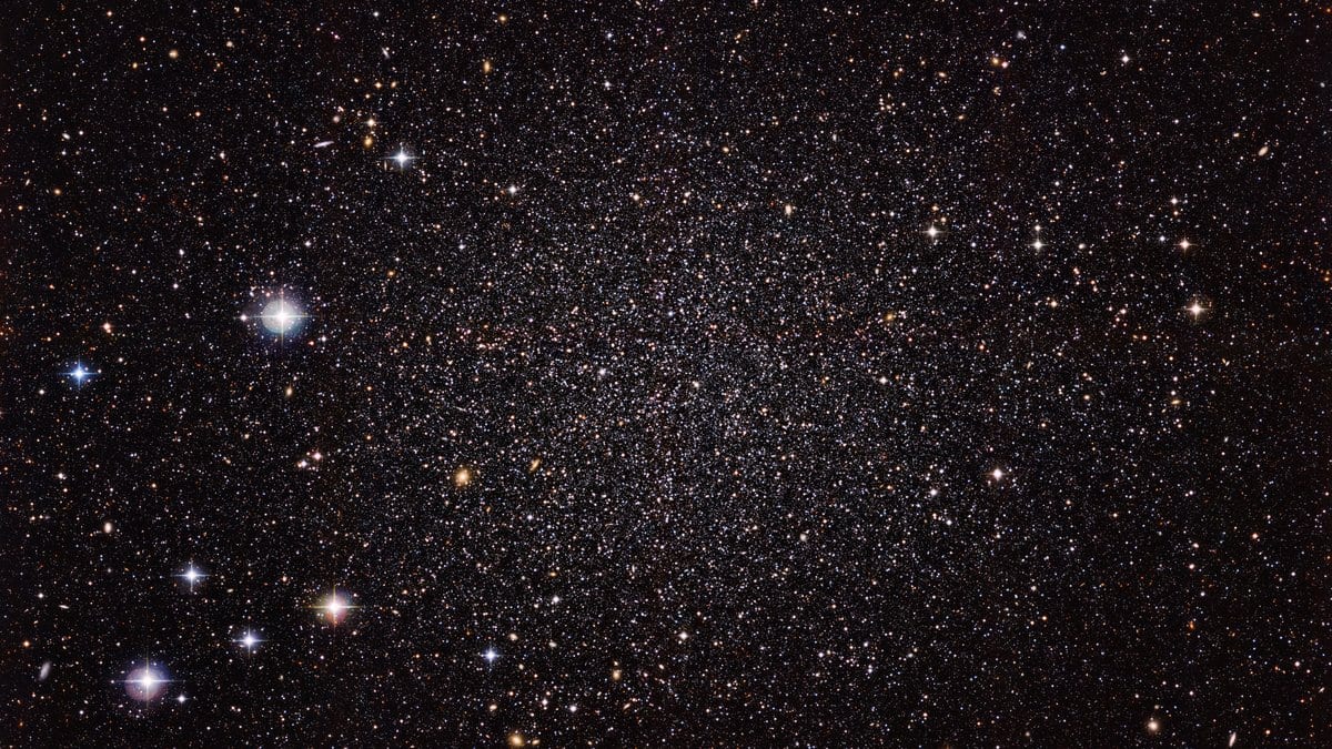 A dense swarm of faint resolved stars filling the frame against a dark sky, the stellar population of a small galaxy near the Milky Way.