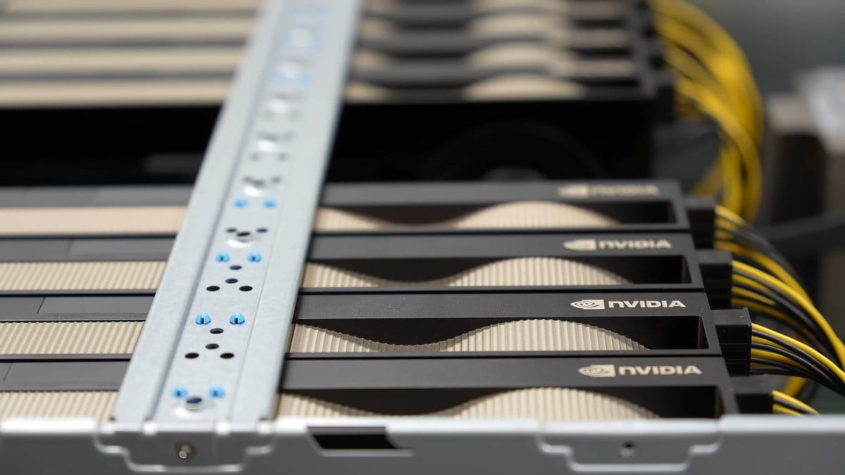 Four graphics cards installed side by side inside a rack-mount server chassis, with yellow power cables alongside them.