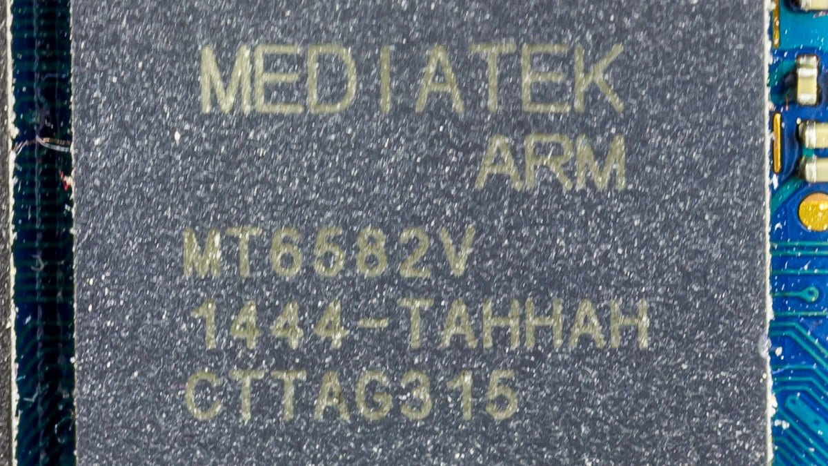Macro photograph of a MediaTek system-on-chip, its part number legible, soldered to the circuit board of a low-cost Android phone.