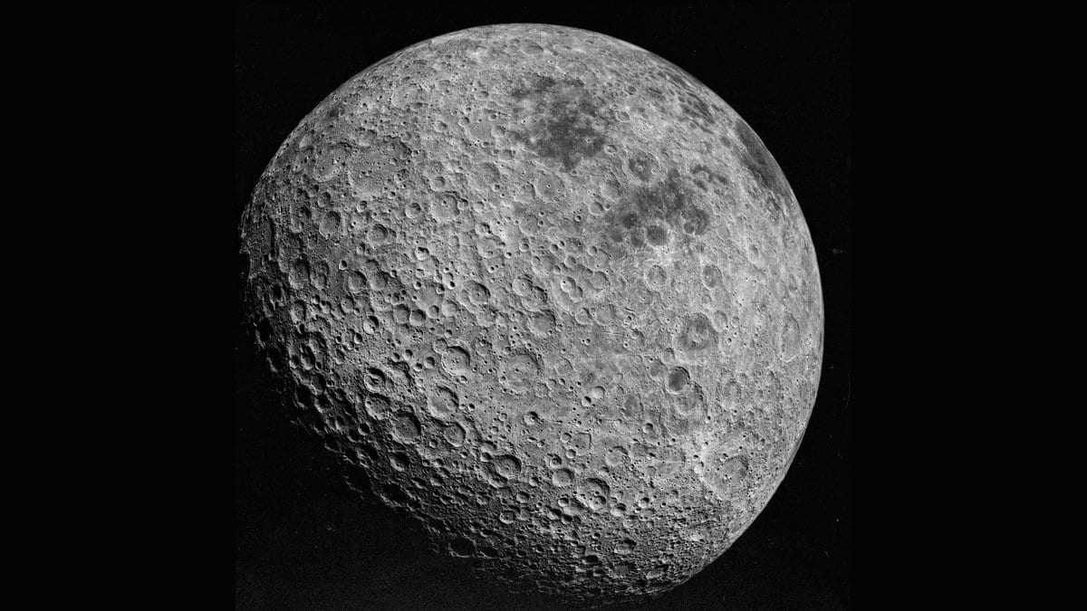The Moon's far side, its surface covered in overlapping impact craters, against black space.