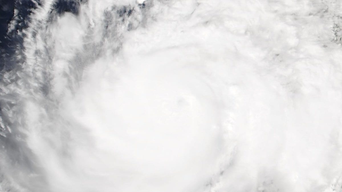 Satellite image of Hurricane Simon showing a well-defined eye surrounded by dense spiral cloud bands over open water
