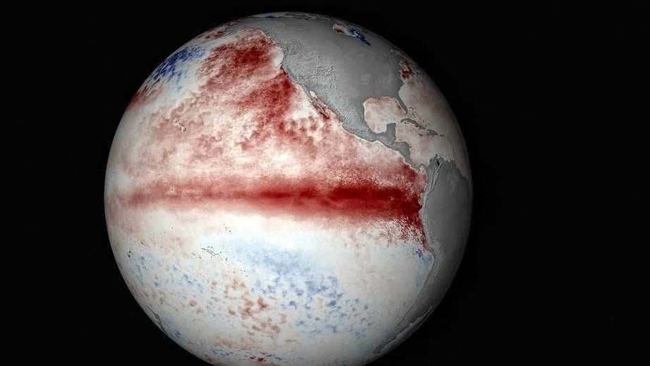A globe centered on the Pacific Ocean, colored by ocean temperature anomaly, with a deep red band of unusually warm water running along the equator.