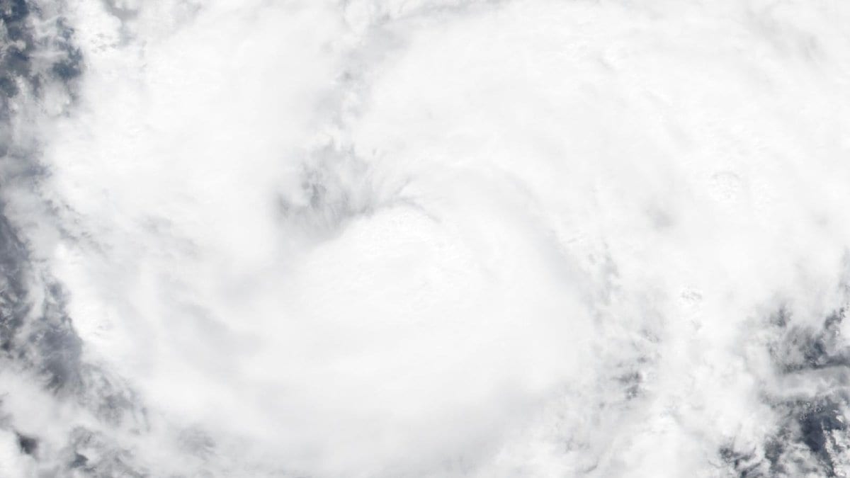 Satellite true-color image of Hurricane Trudy's dense white cloud shield swirling over open ocean
