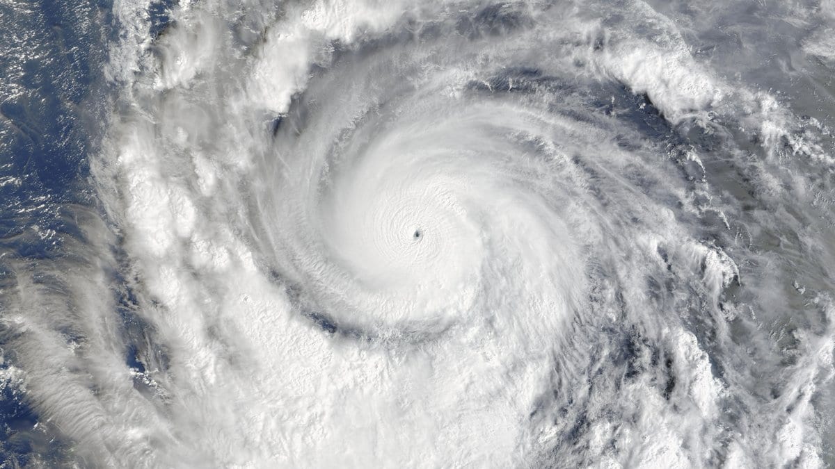 A satellite view of Super Typhoon Champi's compact eye and spiral cloud bands over open Pacific water