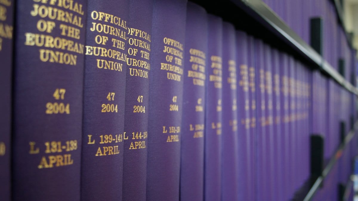 Rows of bound purple volumes of the Official Journal of the European Union on a library shelf, with gold lettering on their spines.