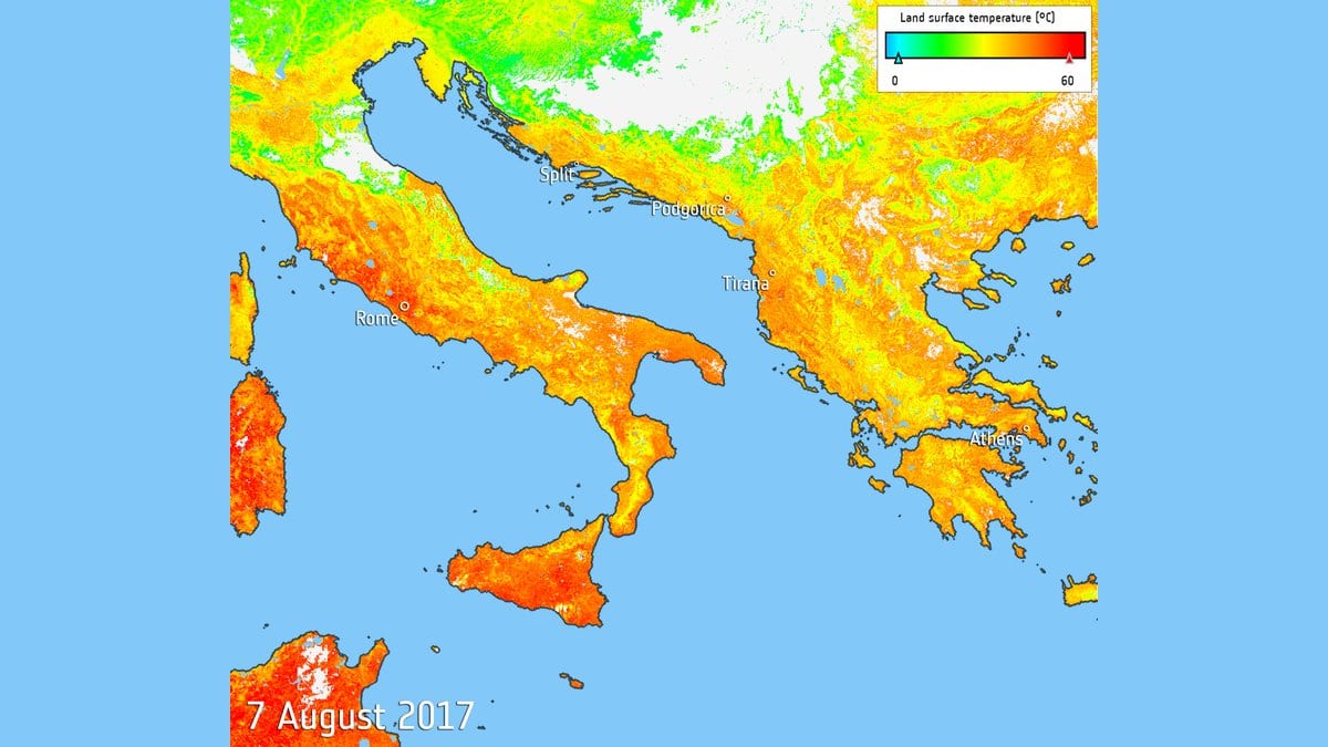 Satellite map of land surface temperature over Italy, the Balkans and Greece, with most land in orange and red against a blue sea, and a scale running from 0 to 60 degrees Celsius.