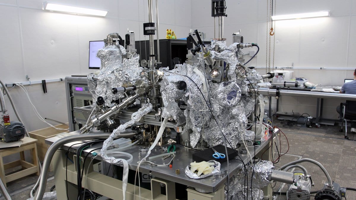 A scanning tunneling microscope built for single-atom magnetic resonance, its vacuum chamber wrapped in foil, standing in a university physics laboratory.