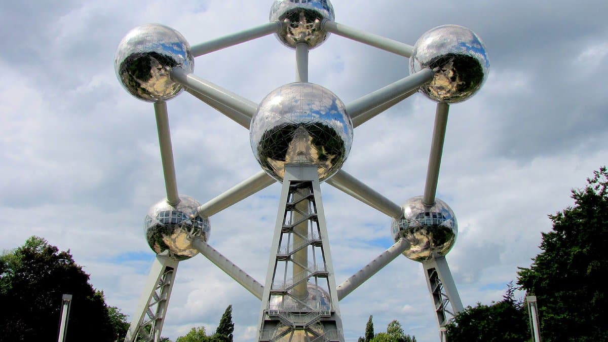 The Atomium in Brussels: nine gleaming spheres joined by tubes into a magnified crystal-lattice structure against the sky.