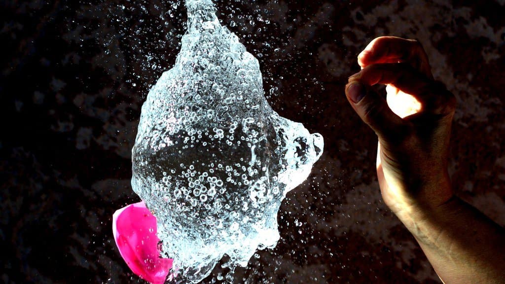 A high-speed photograph of a liquid droplet splash forming a crown