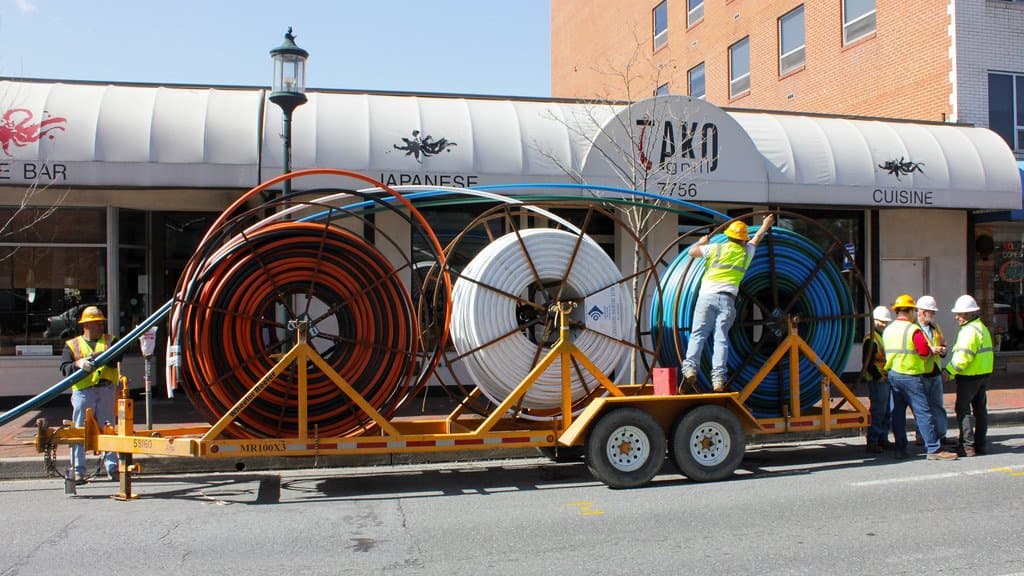 Large spools of fiber-optic telecommunications cable